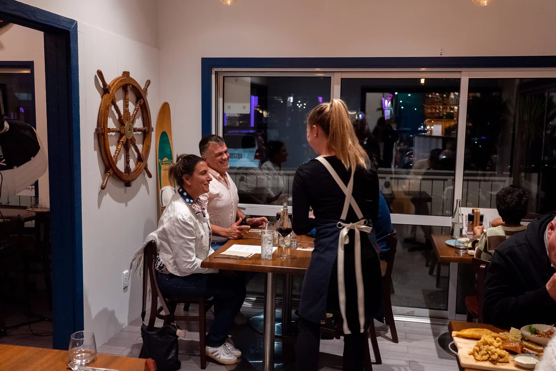 Guests dining at a candlelit table in Saltwood's nautical dining room, Ferrymead.